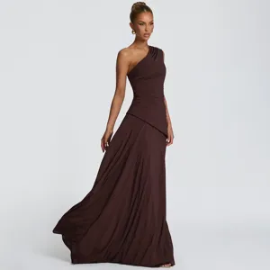 Detail view of elegant one-shoulder pleated maxi dress in deep brown chiffon fabric.