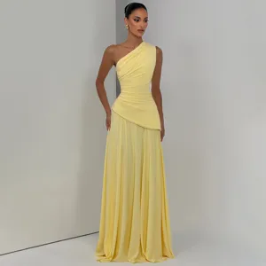 Elegant one-shoulder pleated chiffon maxi dress detail showcasing flowing yellow fabric.