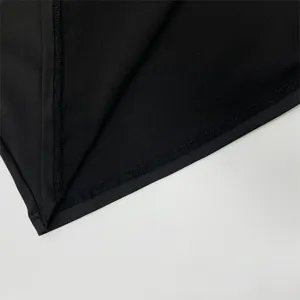 Detailed close-up shot of the black fabric and neat stitching, highlighting craft.