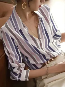 Detail view shot of a women's colorblock striped retro lapel loose long sleeve shirt