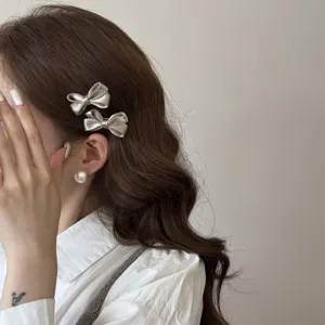 Korean style satin bow hair clips for cute girls, shiny metallic hair accessories.