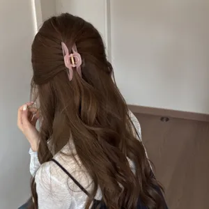 Hollow curved medium hair claw clip, elegant pink shark clip for chic half up hairstyles.