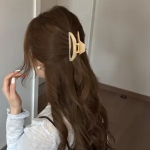 Medium hollow hair claw clip for women, elegant minimalist shark clip for hair styling.