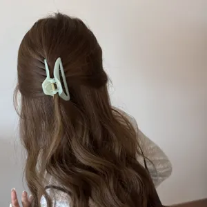 Light green geometric hair claw clip detail shot, elegant half-up hairstyle accessory for daily wear.