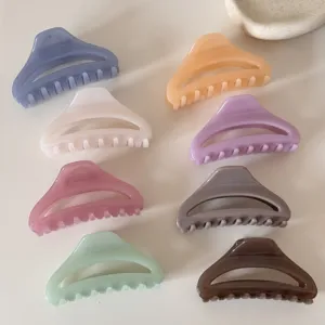 Hollow curved medium hair claw clip, stylish pastel resin shark clips for women and girls daily hair styling.