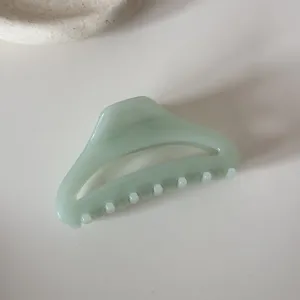 Green hollow hair claw clip, minimalist curved design for women daily hair styling and elegant updos.