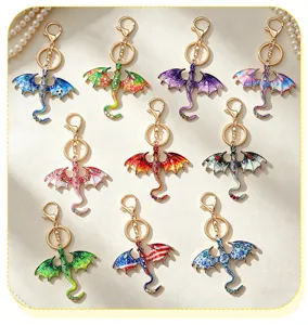 Detailed view of colorful metal dragon keychains, enamel bag charms and key rings in various styles.