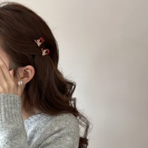 Mini pince à cheveux rouge avec cheval doré et strass pour franges et belles coiffures.