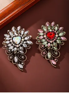 Vintage crystal heart flower brooch detailed close-up, luxury metal alloy pin accessory for women coats.