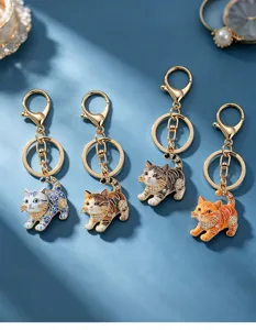 Detailed view of cute cat keychains featuring rhinestone collars and four lovely feline designs.