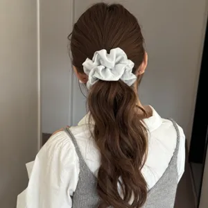White satin hair scrunchie detail view, elegant ponytail holder for daily styling and hair accessories.