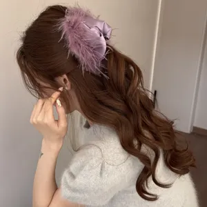 Elegant purple satin feather hair claw clip for women, stylish back head hair accessory.