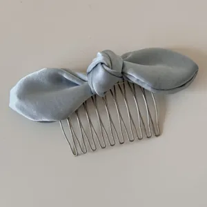 Exquisite light blue satin bow hair comb detail, elegant metal teeth for secure styling.