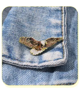 Close-up detail of the spread-wing eagle metal enamel pin, perfect lapel accessory for shirts.