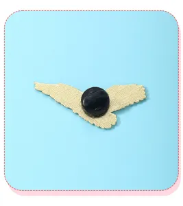 Close-up detail of the golden flying bird metal badge back with secure black rubber clutch.