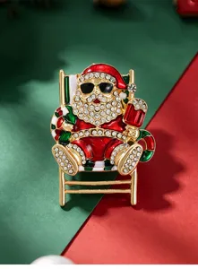 Close-up detail of rhinestone Santa Claus brooch, alloy metal festive pin accessory.