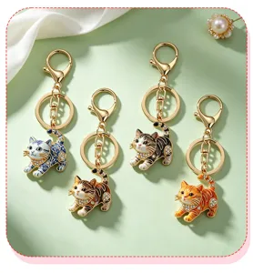 Detailed view of cute cartoon cat keychains with rhinestones and unique patterns for bags.