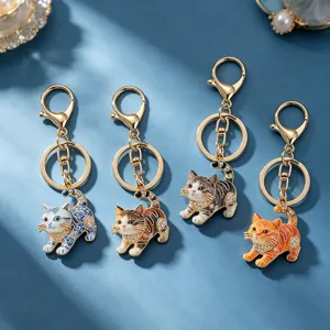 Cute cat keychains set, metal enamel animal keyring for bag decor, creative gift charms.