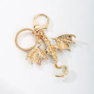 Gold metal dragon keychain and bag charm, stylish fantasy animal pendant accessory for keys.