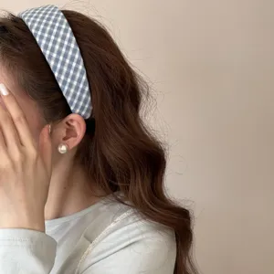 Close-up detail of the stylish blue plaid headband, showing soft fabric texture and daily wear.