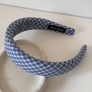 Blue plaid fabric headband detail view, soft sponge padded hair hoop accessory for women.