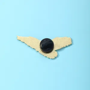 Metal eagle wing lapel pin badge back view on blue background for clothing accessories