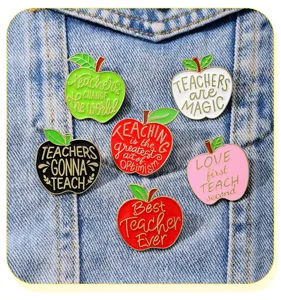 Detail shot of teacher appreciation enamel apple pins set, vibrant colors and inspirational quotes.