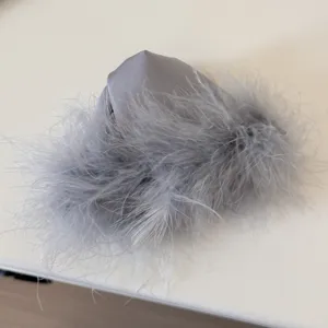 Grey feather hair claw clip fluffy hair accessory elegant design detail view for women styling