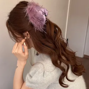 Elegant purple feather hair claw clip for women, fluffy plush hair accessory for styling.