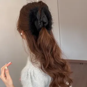 Elegant black feather hair claw clip for women, plush bow shark clip, back headwear main view.