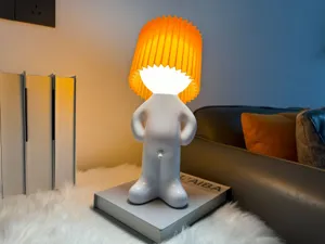 Quirky shy boy USB rechargeable LED night light with pleated orange lampshade for bedroom.