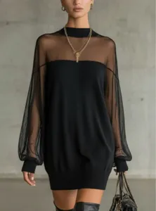 Close-up detail of the black mesh spliced long sleeve high collar bodysuit, stylish slim fit.