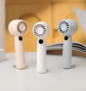 Close-up detail of mini portable handheld fan with digital display and hanging buckle for outdoor use.