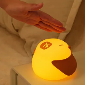 Cute silicone duck tap night light, warm LED bedside lamp with adjustable brightness for bedroom.