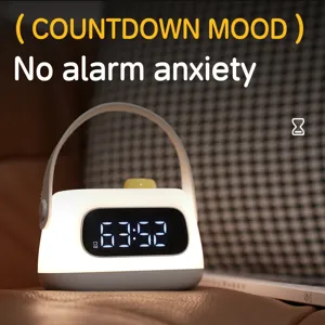 Portable LED digital alarm clock night light with handle USB rechargeable bedside lamp.