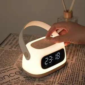 Portable LED alarm clock night light with handle, USB rechargeable bedside lamp and dimmable display.