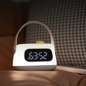 Portable LED alarm clock night light with handle, USB rechargeable silent bedside sleep lamp.