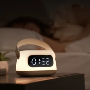 Portable LED alarm clock night light with handle and digital display for bedside bedroom.