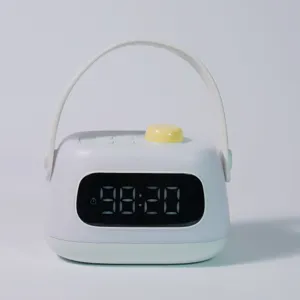 Portable LED digital alarm clock with handle and night light function detail view.