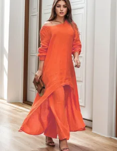 Gedetailleerd overzicht van de elegante oranje linnen top en bijpassende wijde broek.