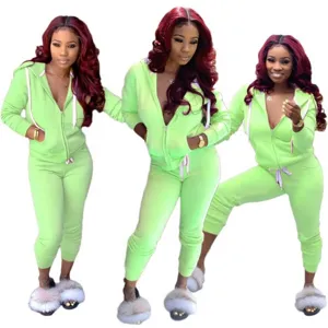 Detail view of women solid color zip up hoodie and joggers tracksuit set in bright green hue.