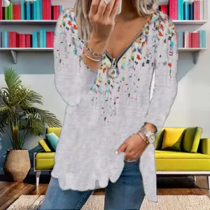 Detailed view of women's V-neck long sleeve blouse with colorful print and front zipper.