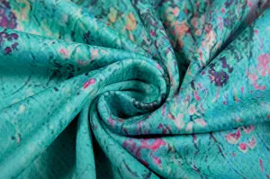 Close-up detail of women's floral fabric, showing soft texture and vibrant floral print.
