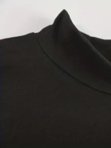 Close-up detail of the black mock neck collar showcasing the fine stitching and soft fabric texture.