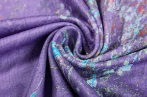 Close-up detail of purple floral fabric material, soft textile texture for long sleeve top.