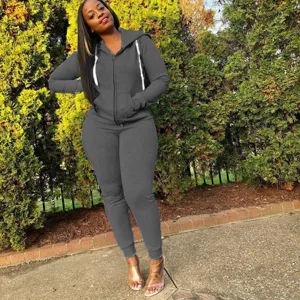 Outdoor detail view of women's solid dark grey zip-up hoodie and sweatpants tracksuit.