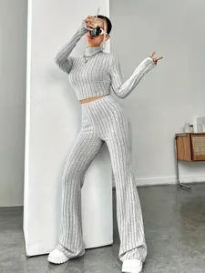 Detailed view of grey ribbed knit two-piece set featuring cropped long sleeve top and flared pants.
