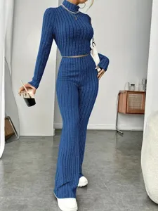 Close-up detail of the ribbed knit long sleeve crop top and flared pants set in blue.