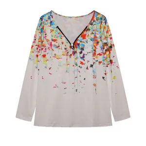 Close up view of women v-neck zip long sleeve colorful abstract splatter print top detail.