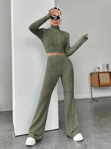 Stylish olive green ribbed knit two-piece set featuring a turtleneck crop top and flared pants.